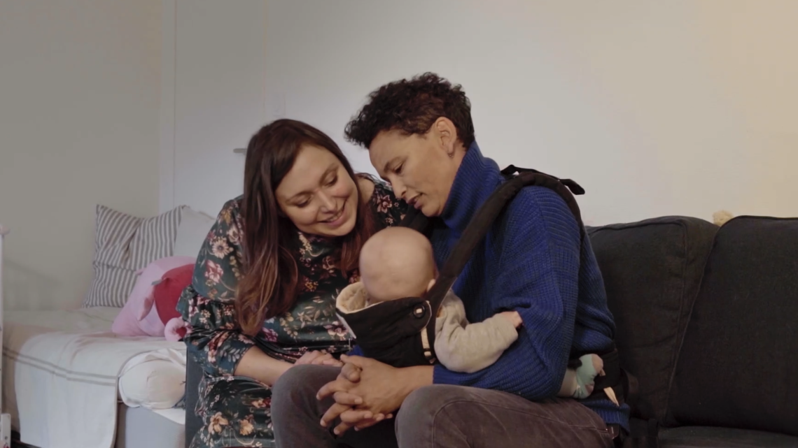 Un couple de femmes regarde tendrement leur bébé